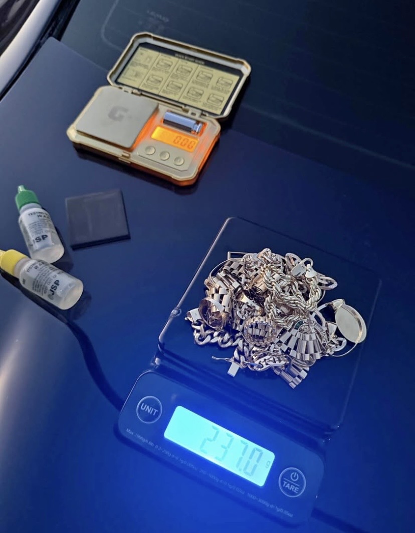 Gold chain being weighed on a professional jewelry scale